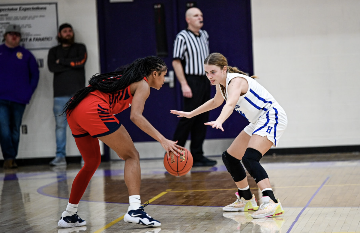 Katie Bucher (11) defends the basket. 